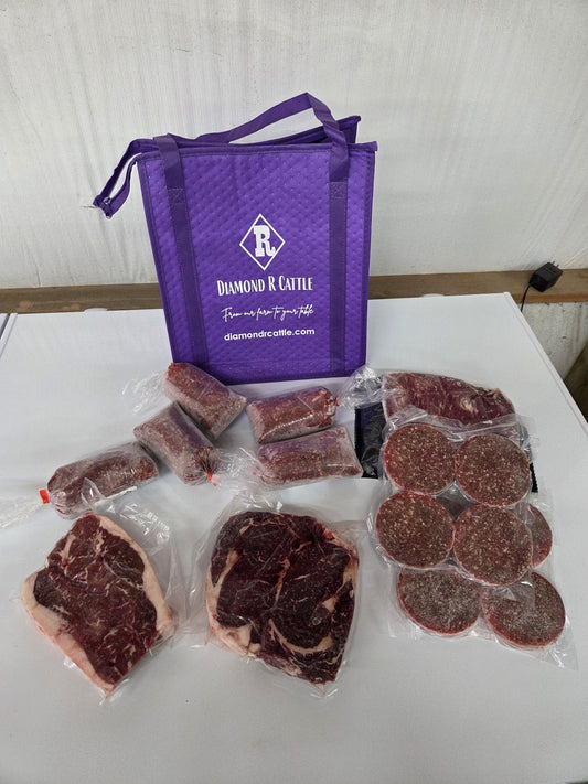 Diamond R Cattle beef box with steaks, roasts and patties beside the purple Diamond R cooler bag