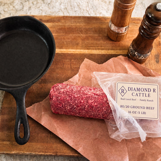 Diamond R Cattle 80/20 single-source ground beef on butcher paper beside a cast iron skillet