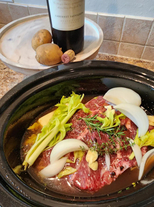 Fork-tender Diamond R slow cooker pot roast with potatoes, carrots and herbs in a bowl