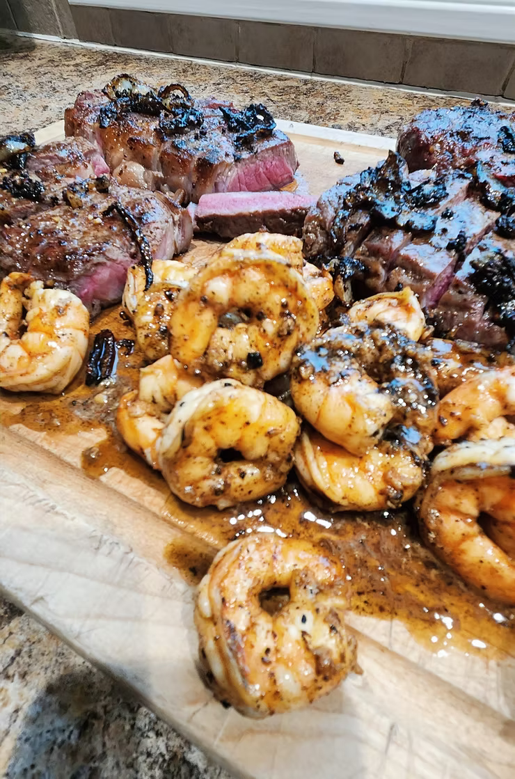 KC strip steak with garlic shrimp scampi on a plate