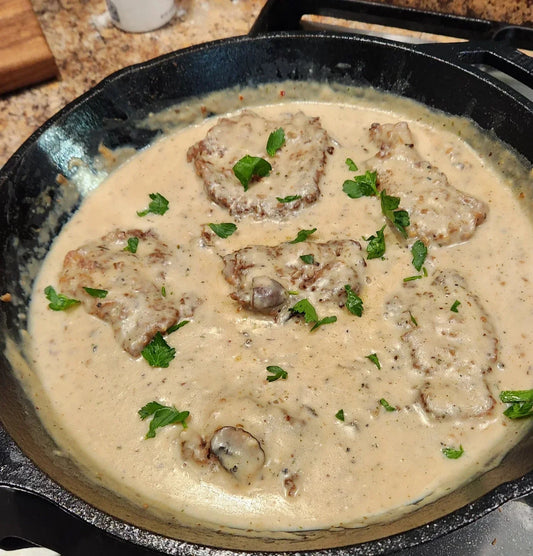 Diamond R minute steak with sauteed mushrooms and creamy gravy over mashed potatoes