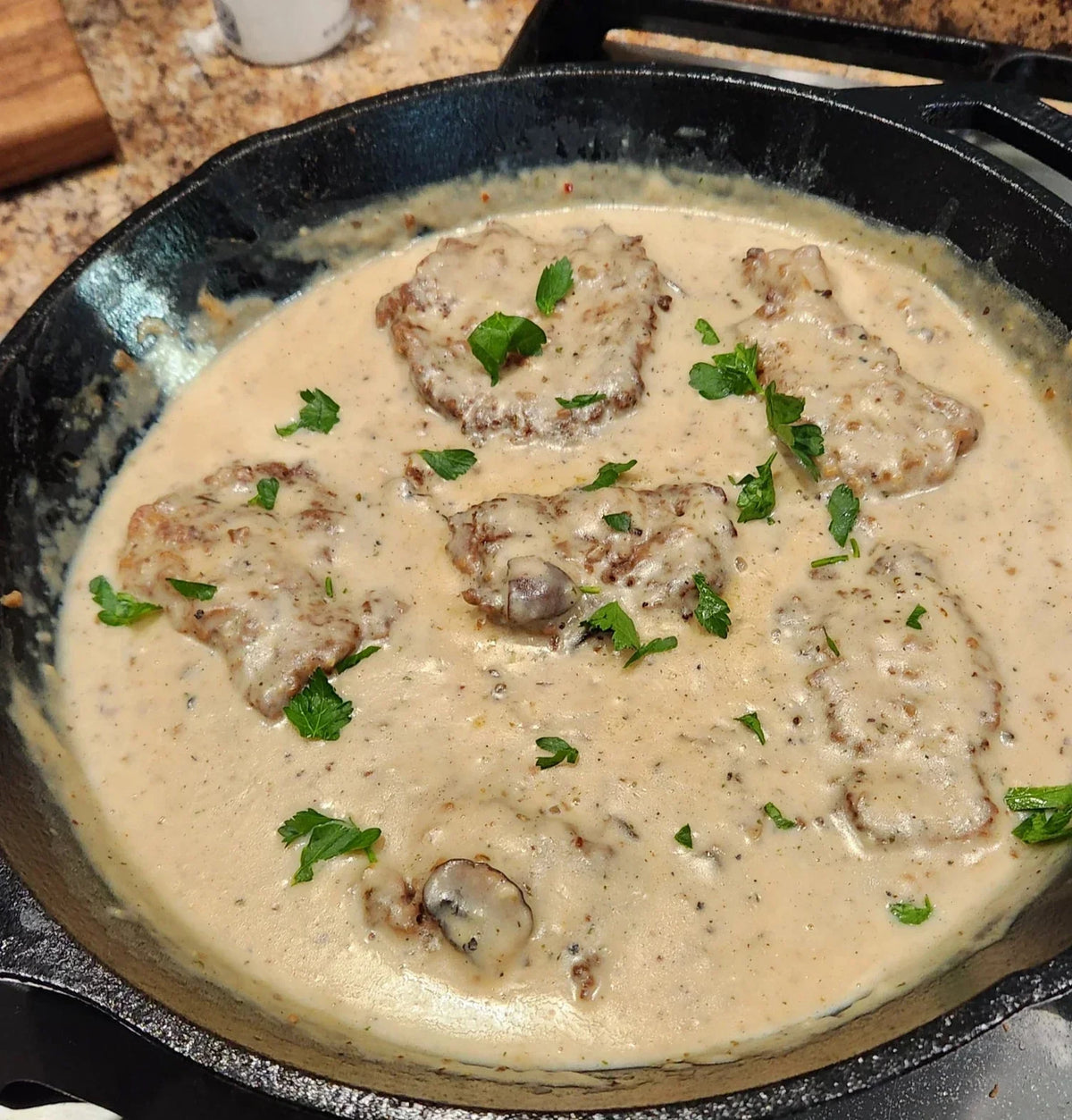 Diamond R minute steak with sauteed mushrooms and creamy gravy over mashed potatoes