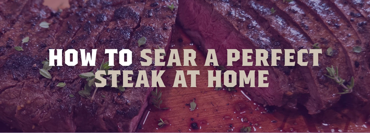 Perfectly seared farm-raised steak resting on a cutting board with butter, garlic, and fresh thyme.