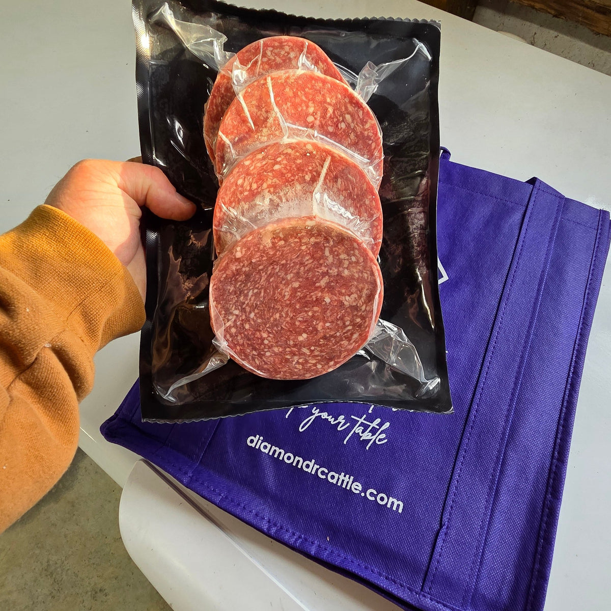 Vacuum-sealed 1/3 lb beef burger patties from a Diamond R Cattle eighth share beef bundle