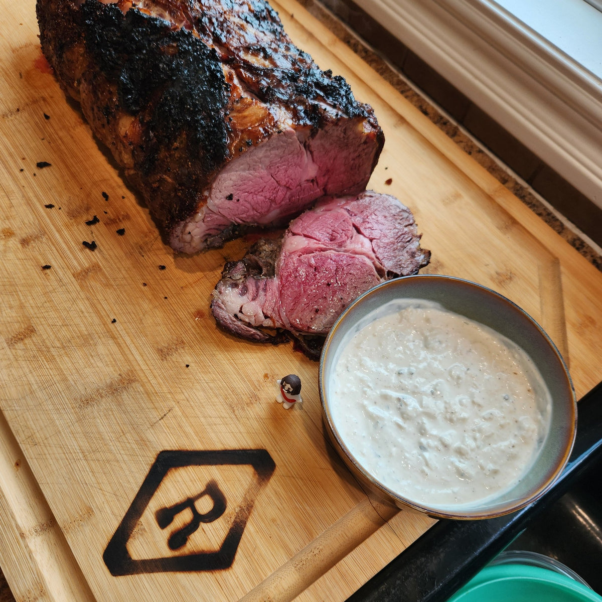Sliced Diamond R Cattle beef roast on a cutting board, the kind of roast included in the eighth share bundle